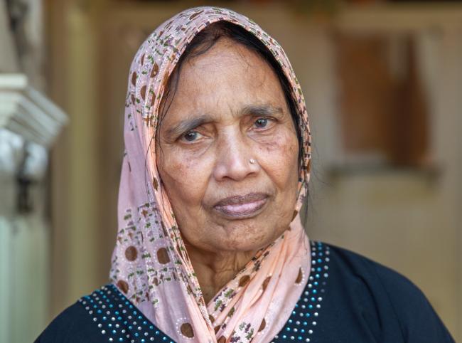 Woman wearing headscarf looking towards the camera