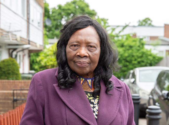 Woman with serious expression standing in street