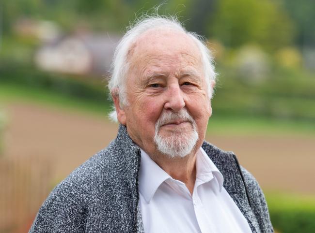 Man wearing fleece jacket looking towards the camera